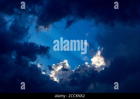 Sunbeams behind clouds Stock Photo