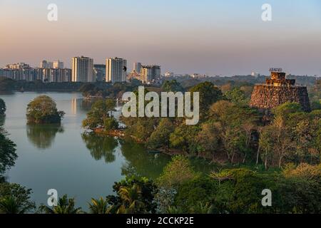 Myanmar, Yangon, Kandawgyi Lake with city skyline at sunset, aerial view Stock Photo