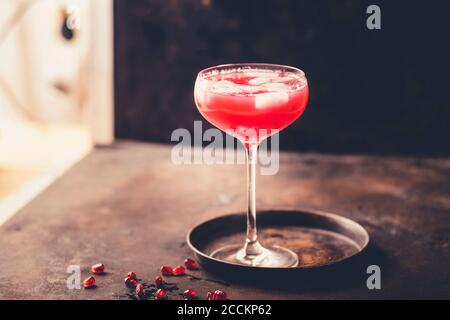 Glass of pomegranate fizz with pomegranate juice, ice cubes and tonic water Stock Photo