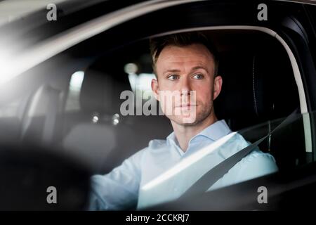 Serious entrepreneur looking away while sitting in car Stock Photo