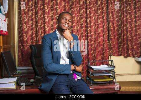 Young African American businessman smiling while posing in his office Stock Photo