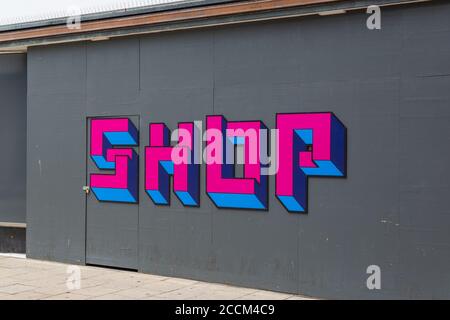 Artwork on the outside of a boarded up shop reading shop Stock Photo