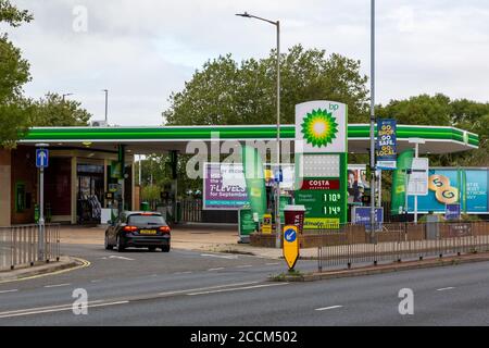 The exterior of a BP petrol station or gas station with a car entering the forecourt Stock Photo