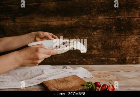Juicy red strawberry lies on the wooden board Stock Photo
