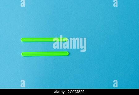 equal sign of sticks on a blue background Stock Photo