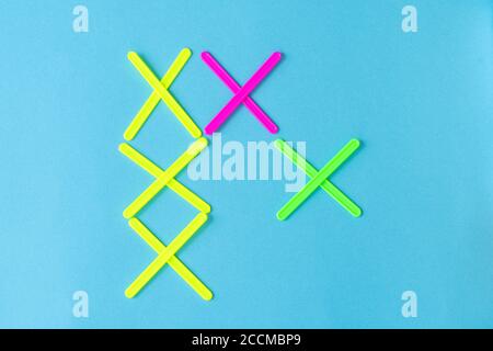 figures from counting sticks in the form of crosses on a blue background Stock Photo