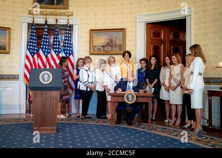 Washington, United States Of America. 18th Aug, 2020. President Donald J. Trump, joined by First Lady Melania Trump, signs a Proclamation on the 100th Anniversary of the Ratification of the 19th Amendment Tuesday, Aug. 18, 2020, in the Blue Room of the White House. People: President Donald Trump Credit: Storms Media Group/Alamy Live News Stock Photo