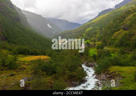 Beautiful Flamsdalen Valley on rainy summer day seen from the Flåm Line railway train between Myrdal and Flåm in Aurland Municipality,Vestland county Stock Photo