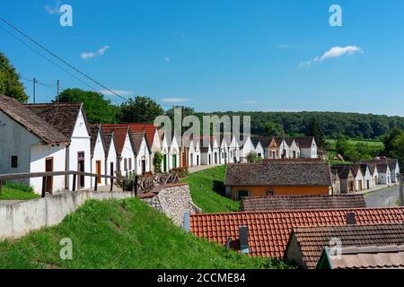 many colorful old traditional wine cellers in Villanykovesd in a hungarian wine region called Villany Stock Photo