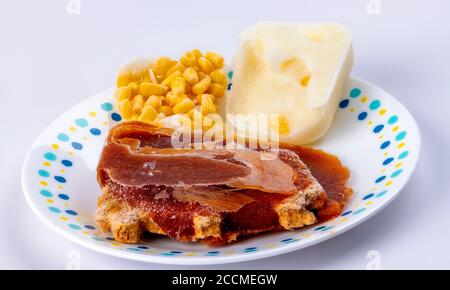 Frozen TV dinner ingredients on a white plate Stock Photo