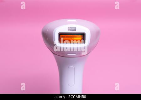 Photoepilator on a pink background. Hair removal tool.
