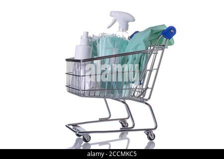 Shopping cart filled with different kinds of desinfectants on white background Stock Photo