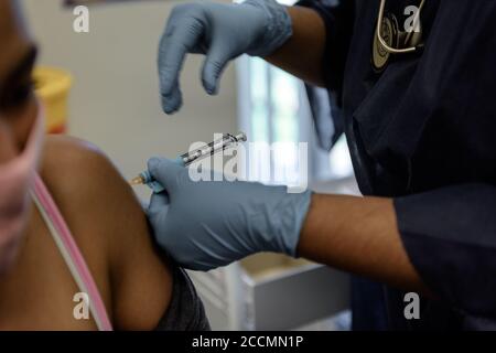 A volunteer for the Oxford vaccine is inoculated at Cape Town's Groote Schuur Hospital in South African trials to test its efficacy against COVID-19 Stock Photo