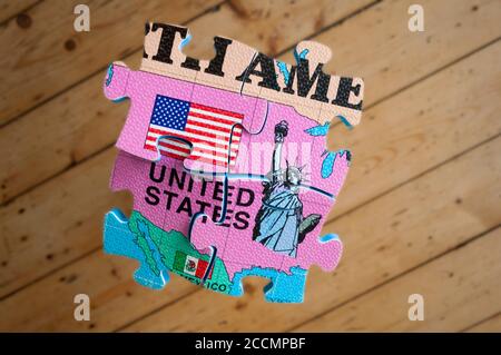 America isolated and splintered, a conceptual image. A puzzle piece on a hardwood floor. Stock Photo