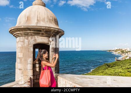Puerto Rico San Juan woman taking phone pictures of Old San Juan Fort Castillo San Felipe Del Morro. Asian tourist people traveling in the USA Stock Photo