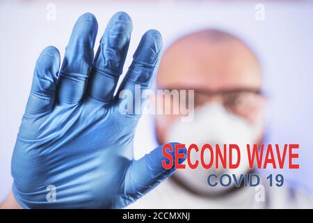 Second Wave Covid-19 - inscription on photo of man in mask and protective gloves, new quarantine of coronavirus.