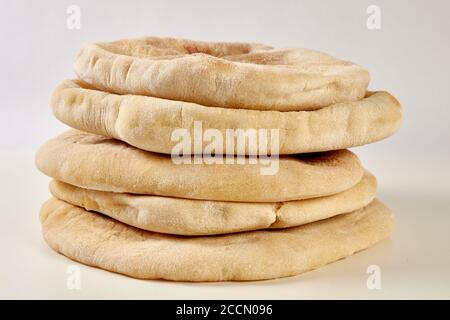 a pile of homemade pita breads on a white background Stock Photo