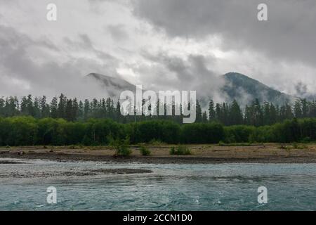 Morning fog clings to the mountains beyond the Hoh River in the Hoh Rain Forest in Olympic National Park Stock Photo