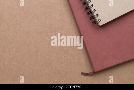 Notebooks on brown cardboard table. Top view. Copy space. Stock Photo