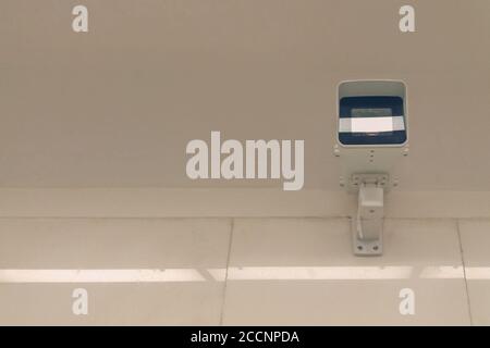 city video surveillance system - security camera under ceiling, front view Stock Photo
