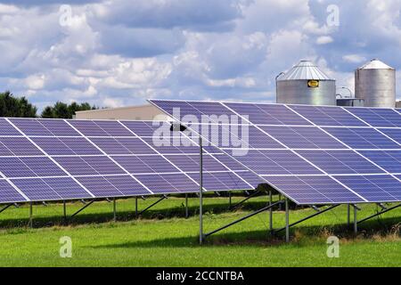Earlville, Illinois, USA. An array of solar panels in a rural setting along a dirt road in a very small north central Illinois community. Stock Photo
