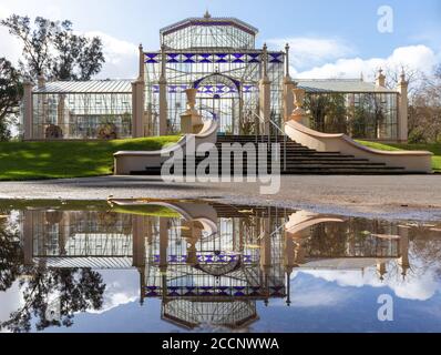 Palm House building at Botanic Gardens, Adelaide, Australia. Restored Victorian glasshouse imported from Bremen, Germany. Building reflected on water Stock Photo