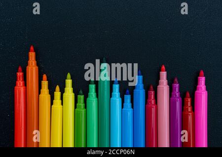 https://l450v.alamy.com/450v/2ccp06n/open-multicolored-markers-closeup-on-black-board-background-place-for-text-2ccp06n.jpg