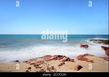 Small waves motion blur on a remote beach in Garig Gunak Barlu National Park, Cobourg Peninsula, Arnhem Land, Northern Territory, NT, Australia Stock Photo