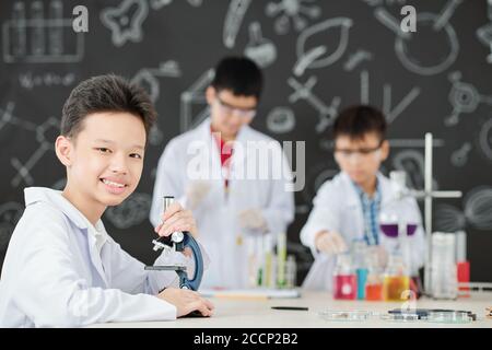 School student with microscope Stock Photo