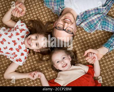 Happy loving family. Daddy and his daughters children girls playing together. Father's day concept. Stock Photo