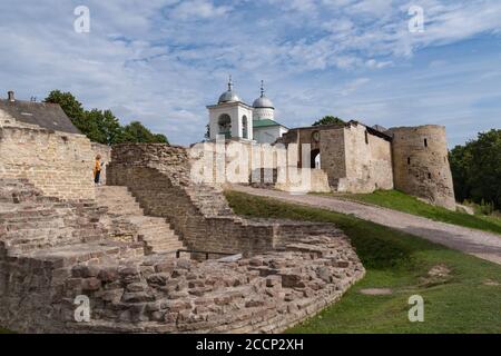 A view of the old Izborsk fortress, Nikolsky's defense sleeve, gates and St. Nicholas Cathedral of 14th century behind the fortified walls. Pskov regi Stock Photo