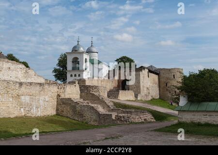 A view of the old Izborsk fortress, Nikolsky's defense sleeve, gates and St. Nicholas Cathedral of 14th century behind the fortified walls. Pskov regi Stock Photo