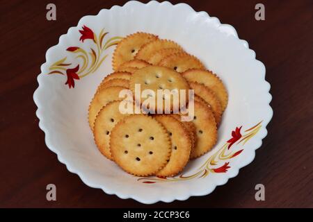 Salted crackers or biscuits in white bowl Stock Photo