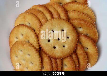 Salted crackers or biscuits in white bowl Stock Photo