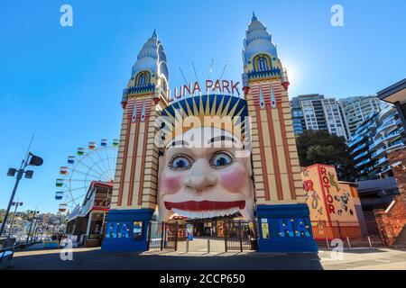 Luna Park, Sydney, Australia. The iconic smiling face entrance and the 35 meter tall Ferris wheel. May 30 2019 Stock Photo