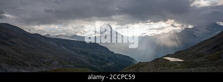 Matterhorn in clouds with sun breaking through after rain Stock Photo