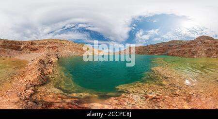 Spherical panorama of emerald lake in a flooded quarry. Emerald green lake in flooded opencast mine. Oval lake in mining industrial crater, acid mine Stock Photo