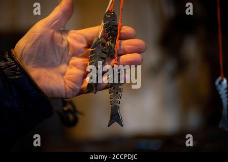 Blacksmith decorative elements metal fish hanging at forge, workshop. Handmade, craftsmanship and blacksmithing concept Stock Photo