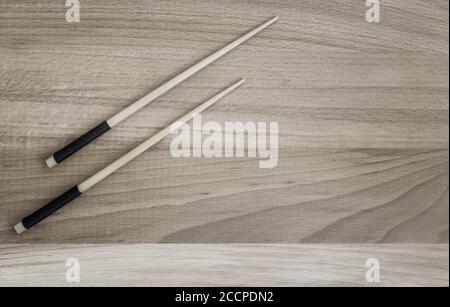 Two wooden chopsticks on a wooden table Stock Photo