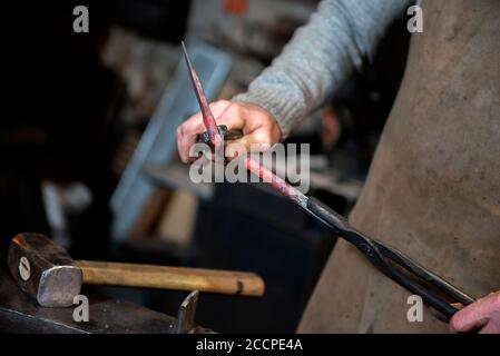 blacksmith working on an anvil Stock Photo