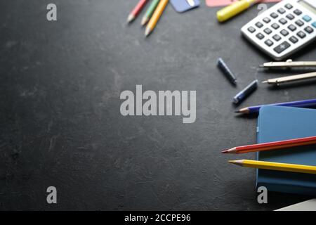 Stationery school supplies on one side of a dark background, office and education concept, copy space, selected focus, narrow depth of field Stock Photo