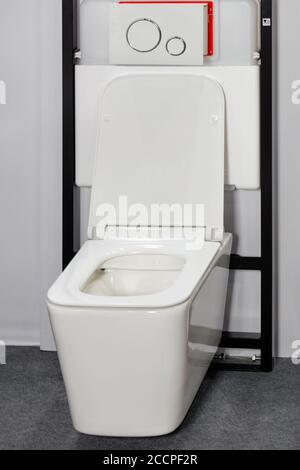 White toilet bowl with modern wall-hanging system and flush mechanism.