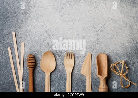 Eco friendly wooden cutlery-spoon, fork, knife, honey dipper, scoop and ice  cream sticks on a grey background. Plastic free concept. Selective focus  Stock Photo - Alamy