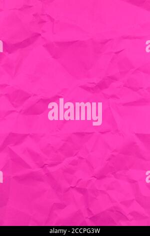 Textured crumpled pink paper background. Vertical Stock Photo