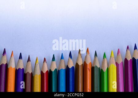 group of colorful wooden pencils on grainy white background and space for text on above Stock Photo