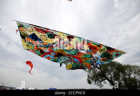 Various kites flying in the blue sky at the kite festival, Zapyskis, Lithuania Stock Photo