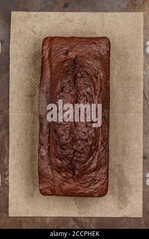 homemade chocolate pound cake loaf on the baking sheet.  Delicious dessert.  Selective focus, top view Stock Photo