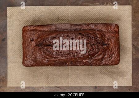 homemade chocolate pound cake loaf on the baking sheet.  Delicious dessert.  Selective focus, top view Stock Photo