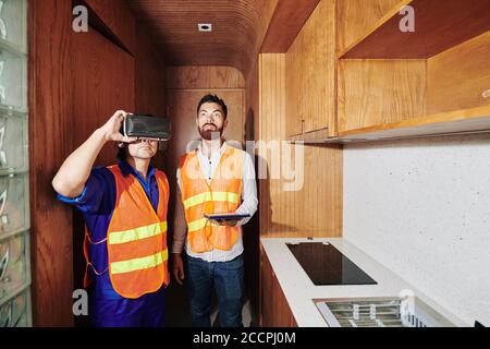 Builder wearing augmented reality glasses to envision how renovated apartment should look Stock Photo