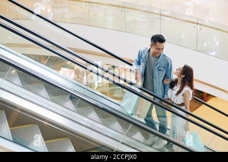 Young couple on escalator Stock Photo